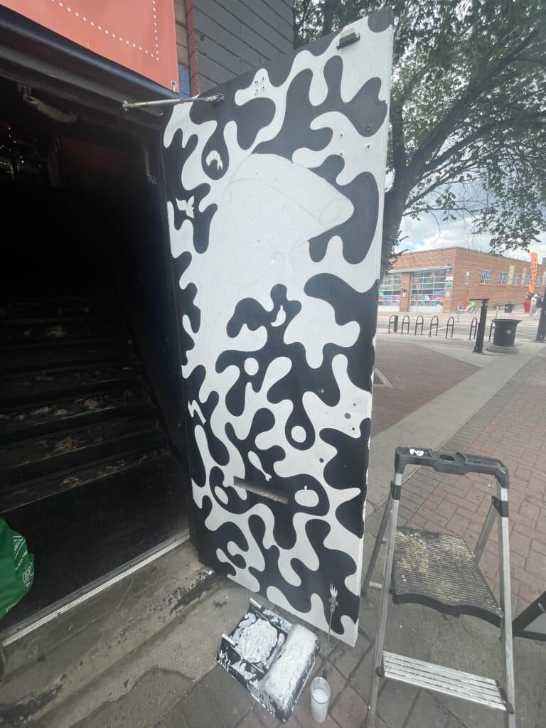 ratchet gold community door mural black and white pizza painting